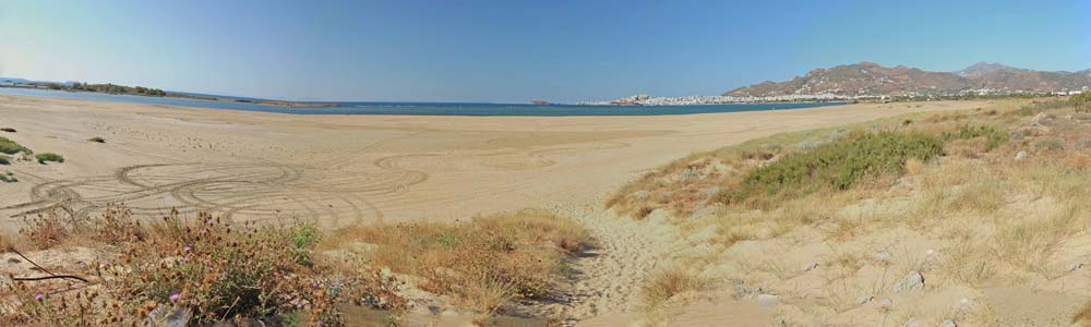 Der Menschenleere Strand mit der Skyline Choras im Hintergrung